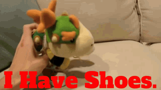 a person holding a stuffed animal with the words i have shoes below it
