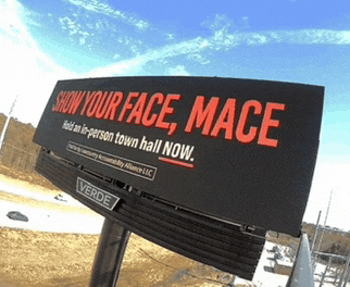 a billboard that says " show your face mace " on it