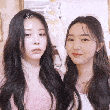 two women are standing next to each other with one wearing a necklace that says ' chanel ' on it