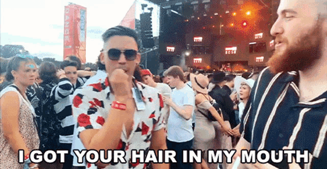 a crowd of people at a concert with the words i got your hair in my mouth