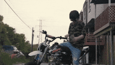 a person is sitting on a dirt bike that says yamaha on the front