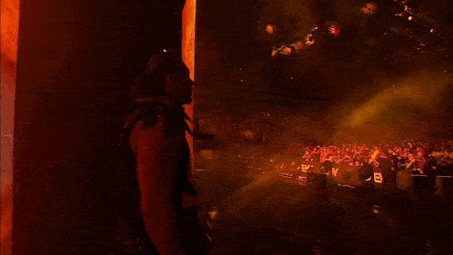 a man in a black vest stands in front of a ring that says ' brooklyn ' on it