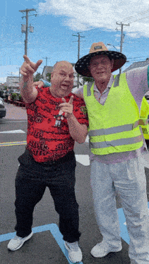 two men are posing for a picture and one of them is wearing a shirt that says " cheesy "