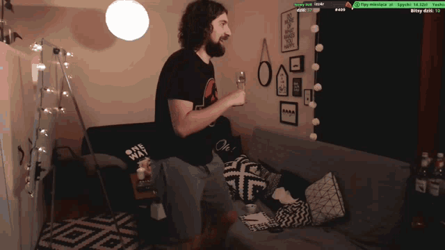 a man with a beard is dancing in front of a couch with a sign that says one way