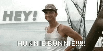 a man in a tank top and hat is standing on a boat in the water .