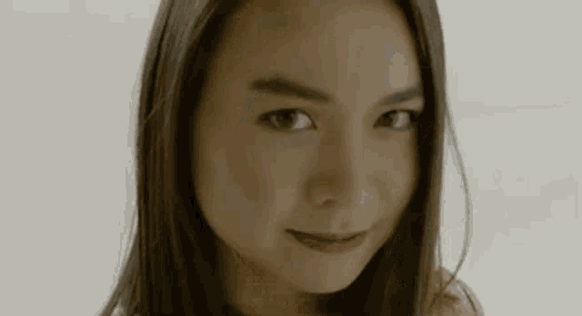 a close up of a woman 's face looking at the camera .