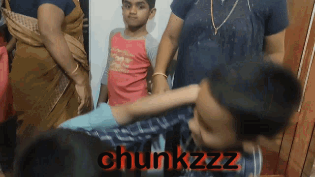 a group of children are standing in front of a sign that says chunkzz