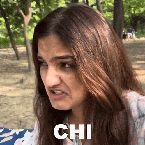 a woman with long hair is making a funny face and the word chi is on her face