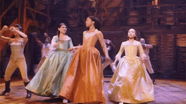 a group of women are dancing on a stage .