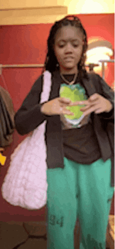 a girl wearing green pants with the number 34 on the side