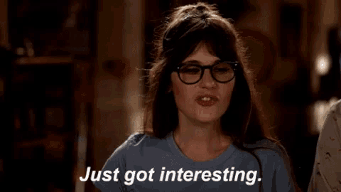 a woman wearing glasses and a blue shirt says " just got interesting "