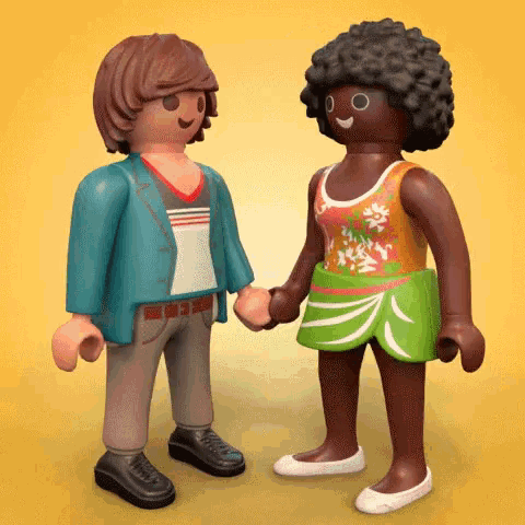 a man and a woman are holding hands while standing next to each other