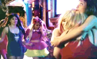 a group of girls are hugging each other in a blurred image