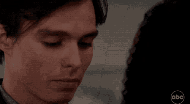 a close up of a man 's face with abc written on the bottom right