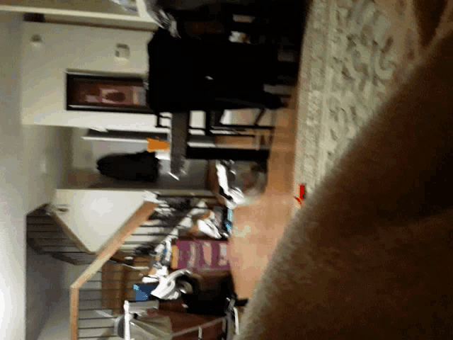 a living room with a staircase and a rug on the floor