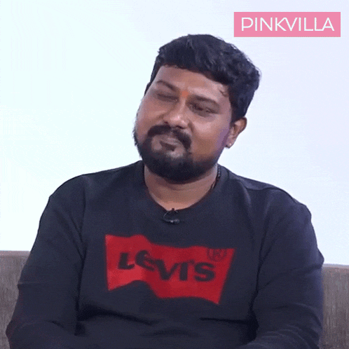 a man with a beard wears a black levis sweatshirt