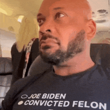 a man wearing a shirt that says joe biden convicted felon on it
