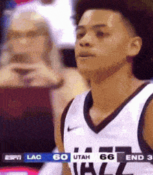 a basketball player wearing a white jersey with utah 66 on it