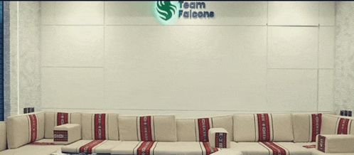 a couch in front of a wall that says " team falcons "