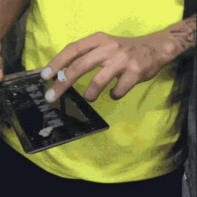a close up of a person 's hands holding a cell phone