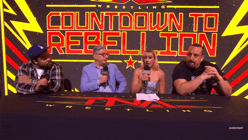 a group of people sitting at a table with the words countdown to rebellion behind them