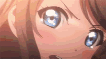 a close up of a girl 's eyes with blue eyes and brown hair .