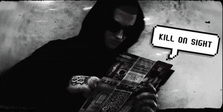 a man in a black hoodie is reading a newspaper .