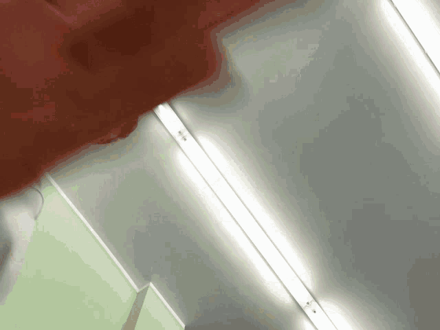 a person is standing in a room with a red shirt on