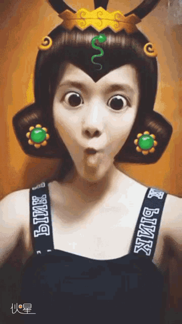 a woman wearing a wig with a green snake on it and pink straps
