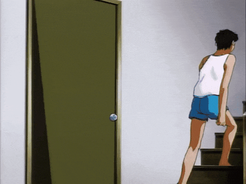 a man in a white tank top and blue shorts is standing in front of a door