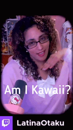 a woman with curly hair and glasses is holding a hello kitty pin and asking am i kawaii