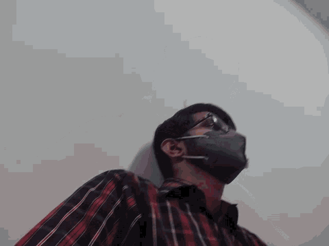 a man wearing a kn95 mask and sunglasses