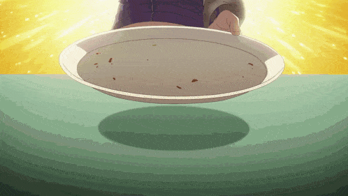a person is holding a plate of food on a green table