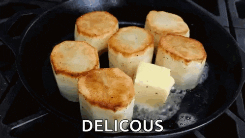 potatoes are being cooked in a skillet with butter and the word delicious written above them .