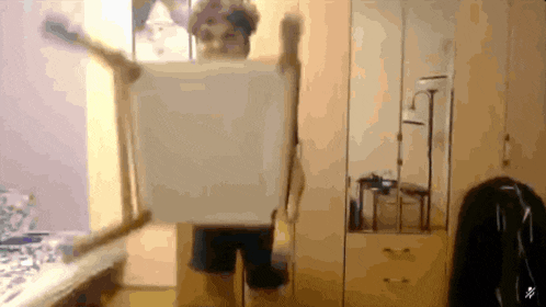 a blurry picture of a person standing in a room with a mirror