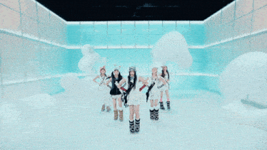 a group of girls are dancing in a room with white balloons