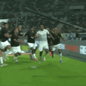 a group of soccer players are running on a field with the number 11 on their shirt