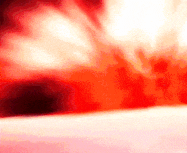 a red and white background with a few spots of light