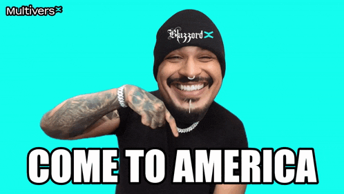 a man wearing a beanie and a t-shirt says come to america