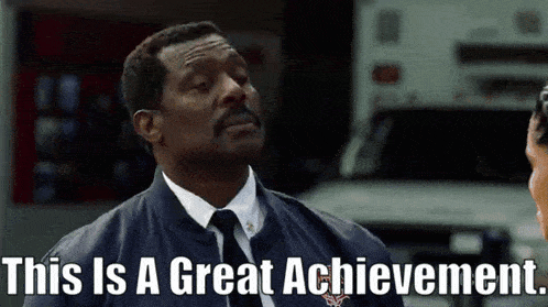 a man in a suit and tie with the words this is a great achievement