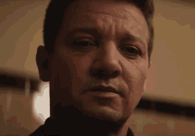 a close up of a man 's face with a serious expression on his face .