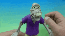 a person is holding a toy skeleton with a purple shirt on
