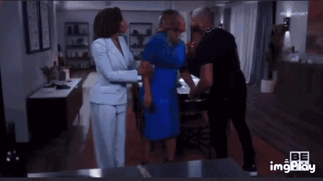 a woman in a blue dress is being held by a man in a suit