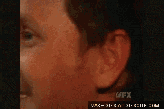 a close up of a man 's face with a mfx logo in the background