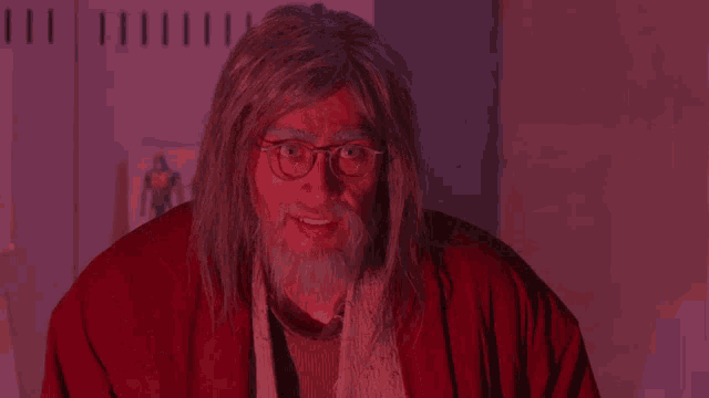 a man with long hair and a beard wearing glasses