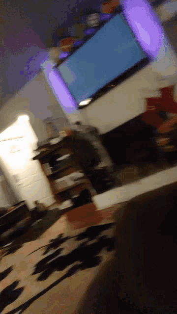 a blurry picture of a living room with a flat screen tv on the wall