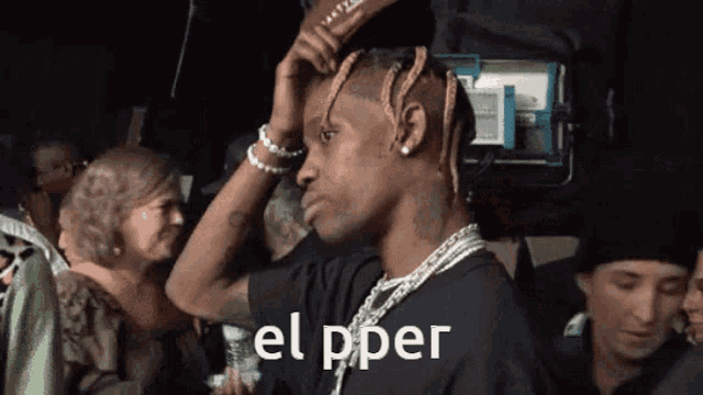 a man with dreadlocks is wearing a black shirt that says el pper