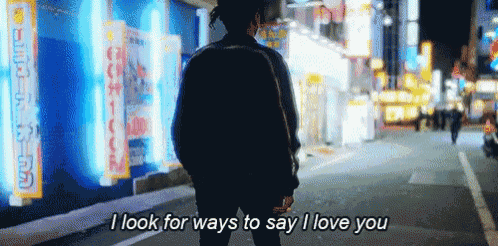 a man is walking down a street with the words i look for ways to say i love you