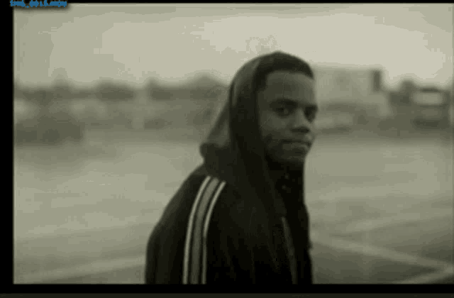 a black and white photo of a man in a hooded jacket with a watermark that says img_0013.mov