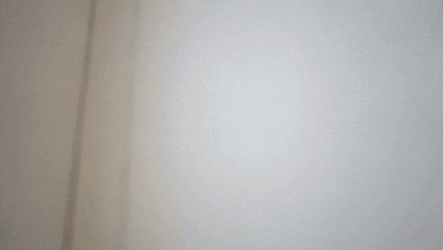 a close up of a white wall with a brown border